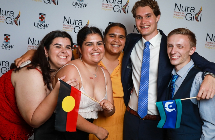 Students holding flags at Indigenous Student Awards evening